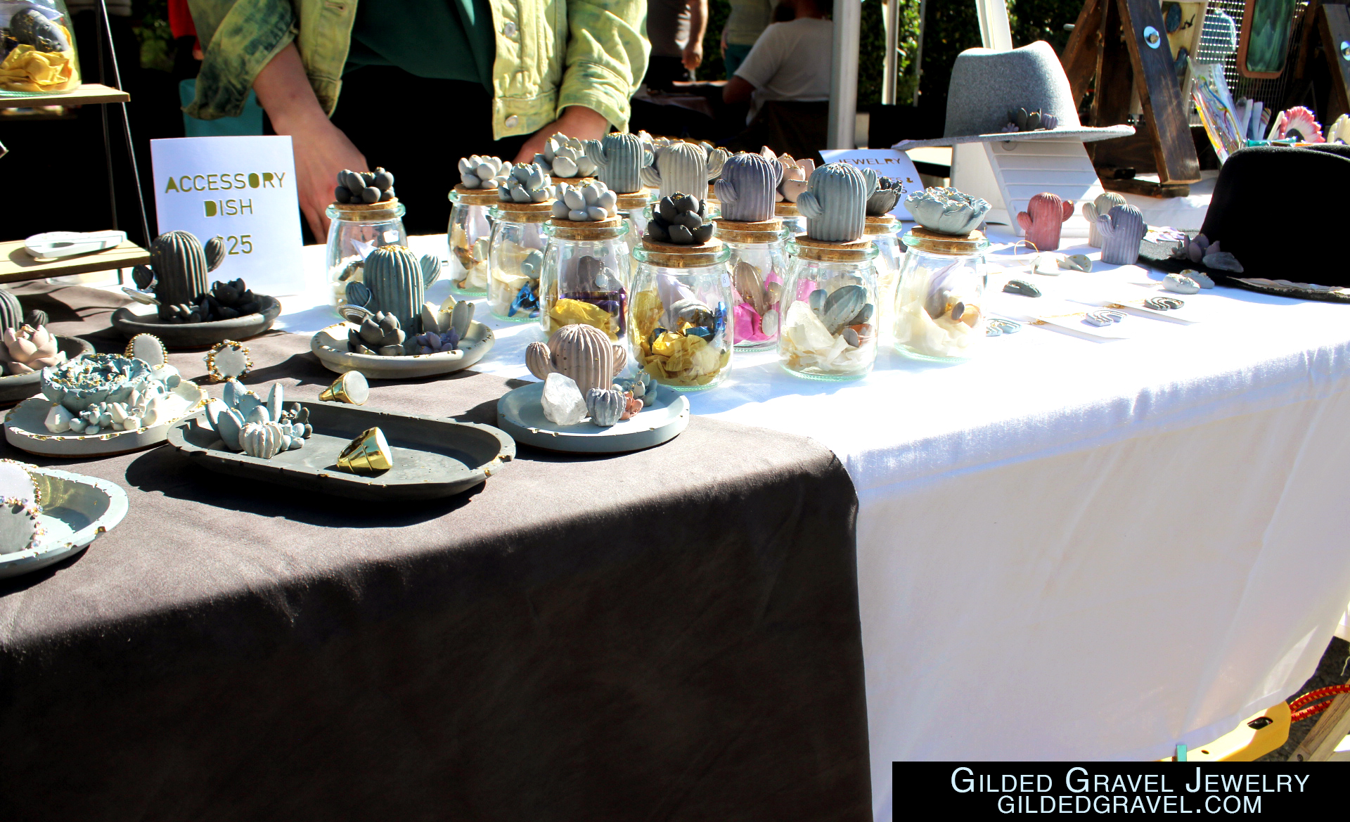 Multiple concrete made accessories, decor, and jewelry lie out on display on a table.

Gilded Gravel Jewelry 
GildedGravel.com
