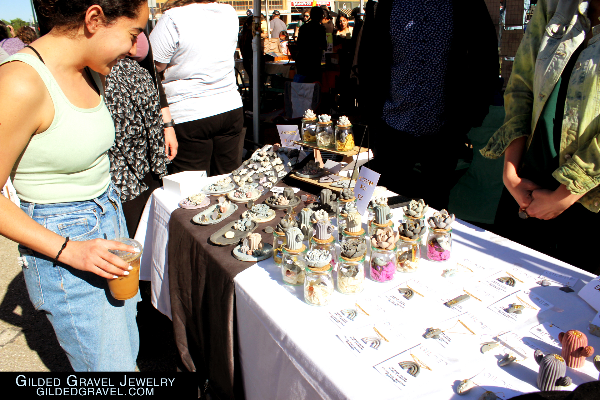 A woman is seen looking at the concrete jewelry and wares.

Gilded Gravel Jewelry
GildedGravel.com
