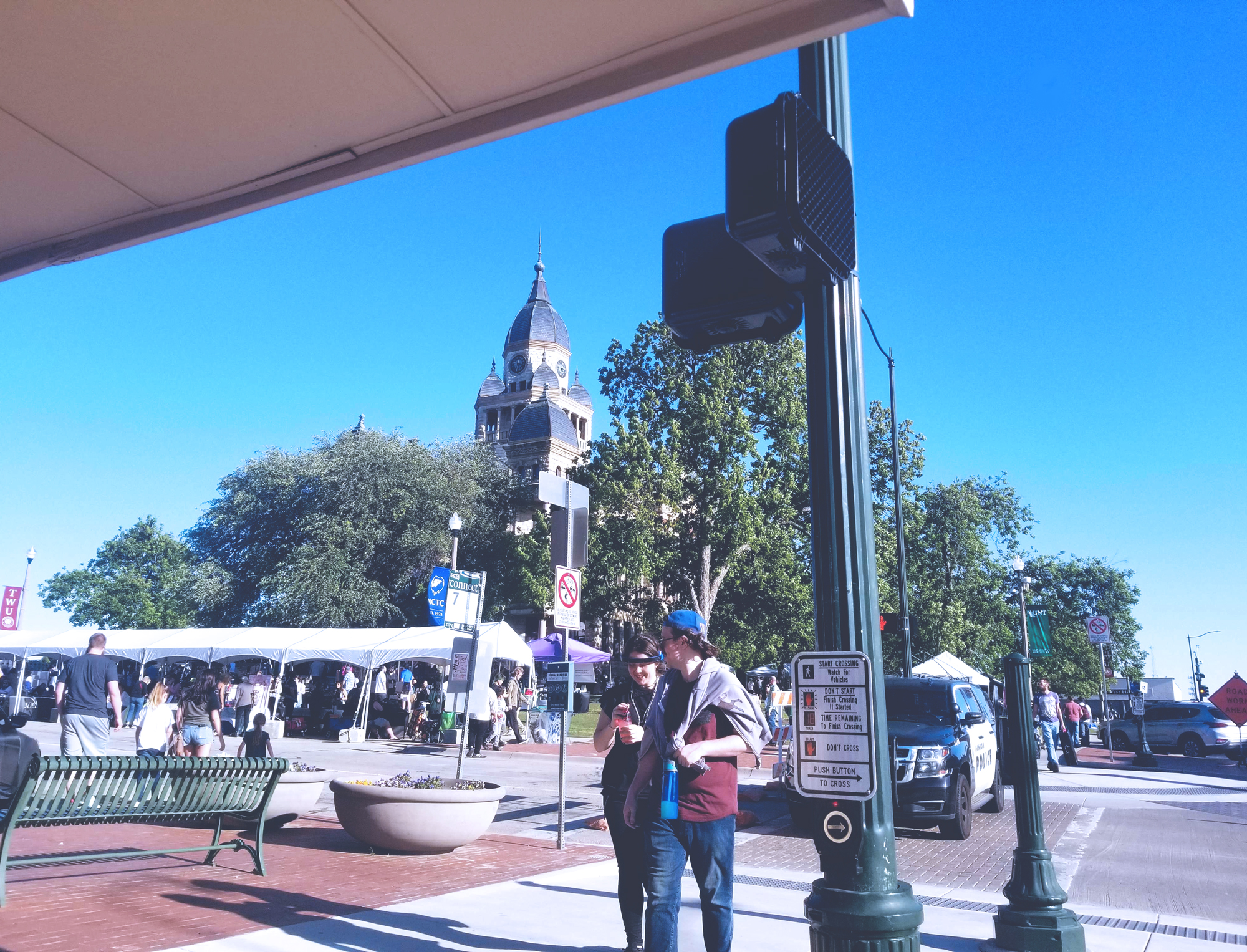 A look at the courthouse on the square with the vendors still working, looking at the booths from afar across the street. 